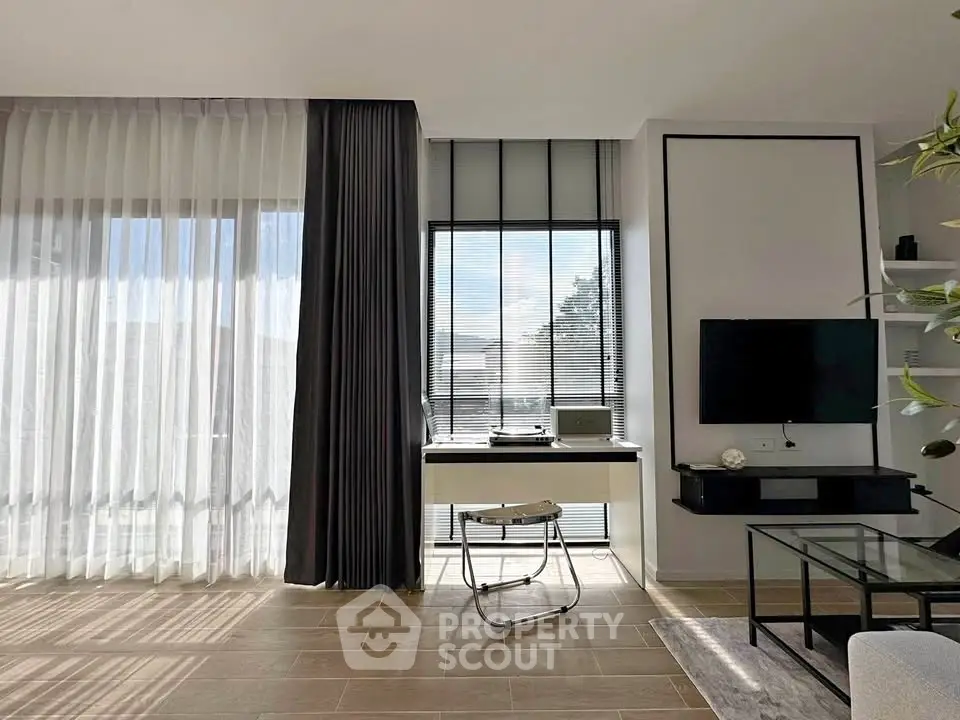 Modern living room with large windows and stylish decor