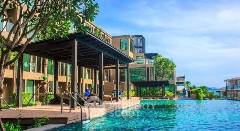 Luxurious resort-style pool area with modern architecture and lush greenery.