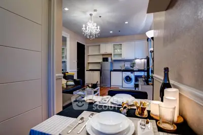 Chic open-layout kitchen and dining area with modern appliances and elegant decor.