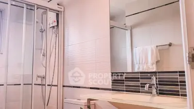 Modern bathroom with glass shower and sleek fixtures