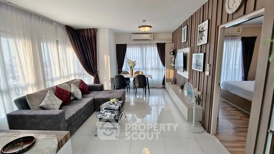 Spacious modern living room with elegant decor and ample natural light in a luxury apartment.