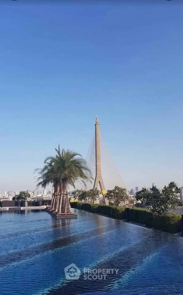 Stunning rooftop pool with panoramic city views and iconic tower in the background.