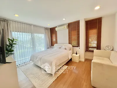 Spacious bedroom with large windows and modern decor, featuring a cozy bed and stylish blinds.