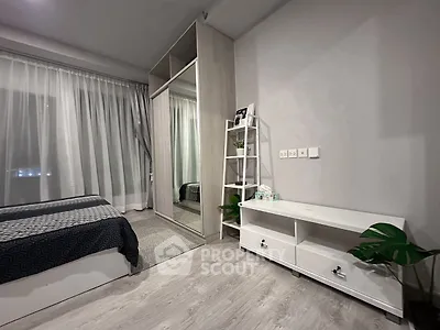 Modern bedroom with sleek wardrobe and stylish decor, perfect for urban living.