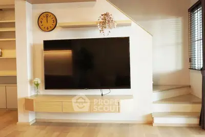 Modern living room with wall-mounted TV and stylish decor