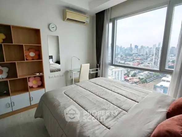 Modern bedroom with city view, featuring cozy bed and stylish decor.