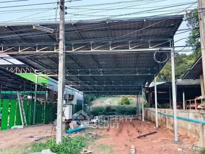 Spacious industrial warehouse under construction with metal roofing and open layout.