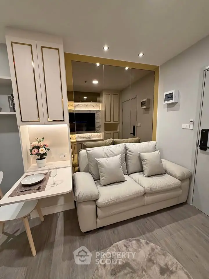 Modern living room with elegant decor and cozy seating in a stylish apartment.