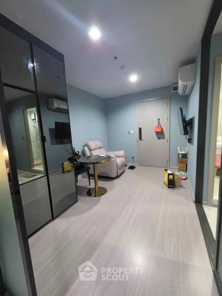 Modern living room with sleek design and comfortable seating in a stylish apartment.