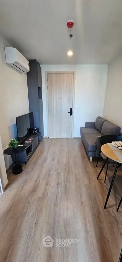 Modern living room with sleek furniture and wooden flooring