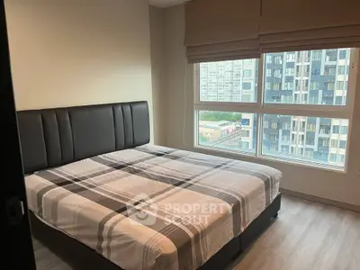 Modern bedroom with large window and stylish bed in urban apartment