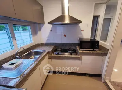 Modern kitchen with granite countertops and gas stove in cozy home