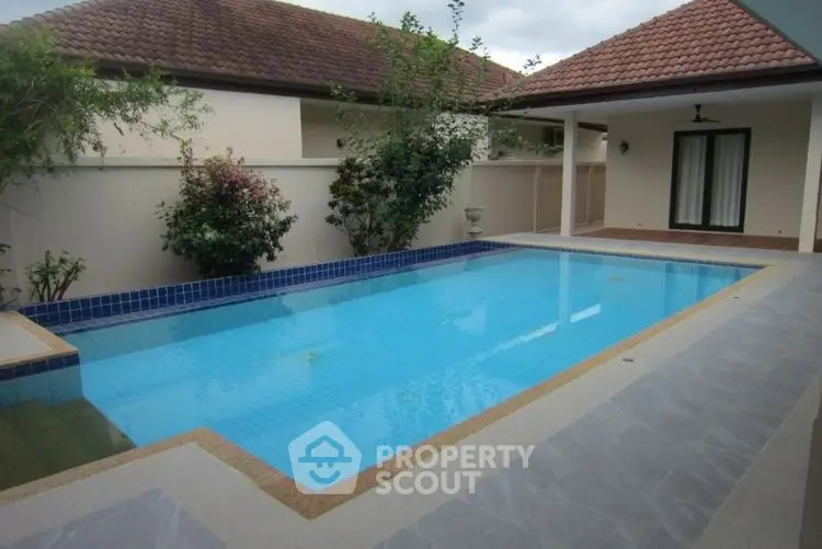 Luxurious private villa with serene pool and elegant patio area.
