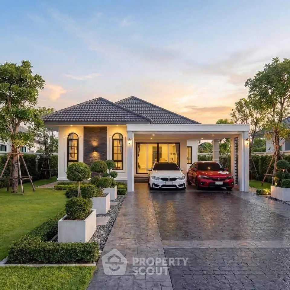 Stunning modern house with landscaped garden and spacious driveway at sunset.