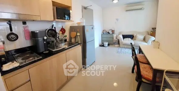 Cozy open-layout kitchen and living room with modern appliances and stylish decor.