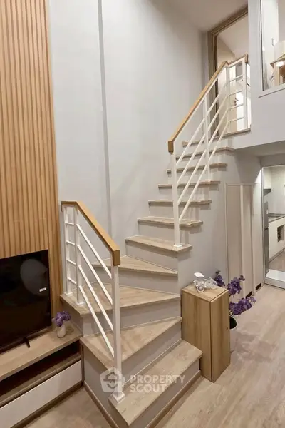Modern duplex interior with stylish staircase and cozy living area