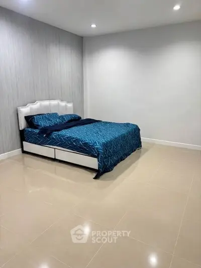 Spacious bedroom with modern design and elegant blue bedding