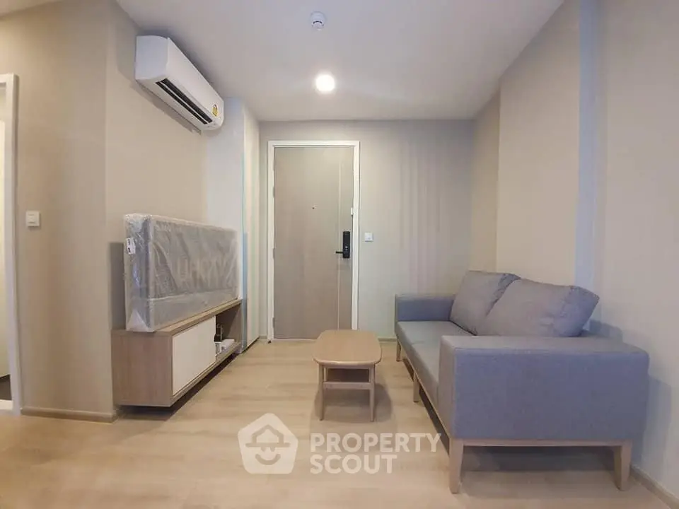 Modern living room with sleek furniture and air conditioning in a stylish apartment.
