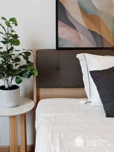 Cozy bedroom with modern decor and stylish plant accent