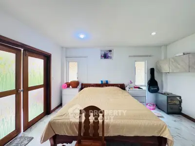 Spacious bedroom with wooden furniture and natural light