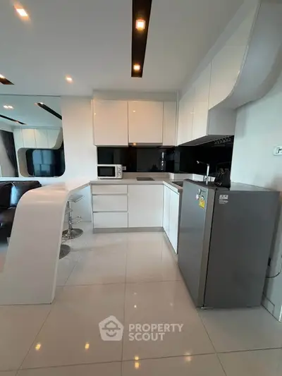 Modern kitchen with sleek white cabinets and open layout in stylish apartment