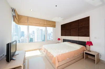 Modern bedroom with city view, featuring large windows and stylish decor.