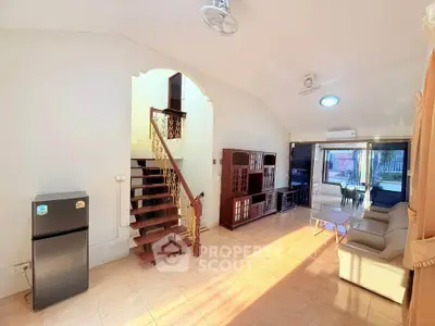 Spacious living room with elegant staircase and modern furniture