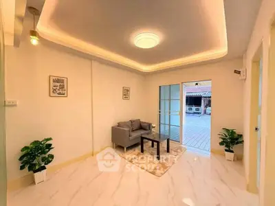 Spacious modern living room with elegant lighting and stylish decor, featuring a cozy sofa and glass coffee table.