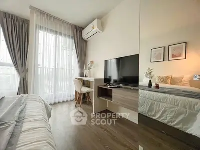 Modern bedroom with stylish decor, featuring a cozy bed, sleek TV setup, and elegant desk by a large window.