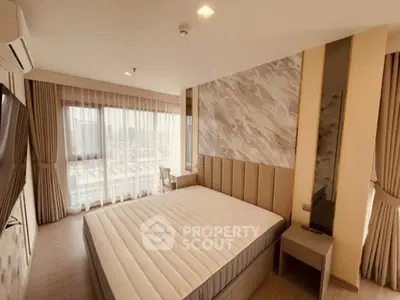 Luxurious bedroom with modern decor and large windows offering stunning city views.