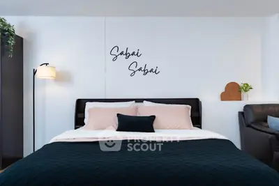 Modern bedroom with stylish decor and cozy bedding in a contemporary apartment.