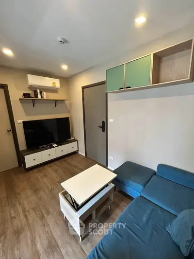 Modern living room with stylish furniture and wall-mounted TV, perfect for relaxation.