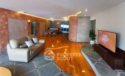 Spacious modern living room with stylish decor and wooden flooring, perfect for relaxation and entertainment.