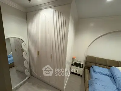 Modern bedroom with stylish wardrobe and cozy bed setup