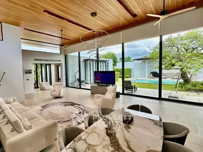 Luxurious open-plan living room with pool view, modern decor, and elegant marble dining table.