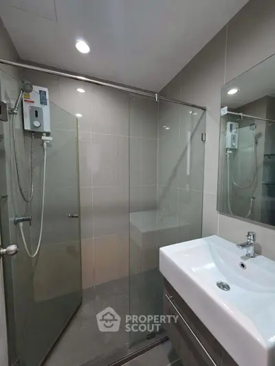 Modern bathroom with glass shower and sleek sink design