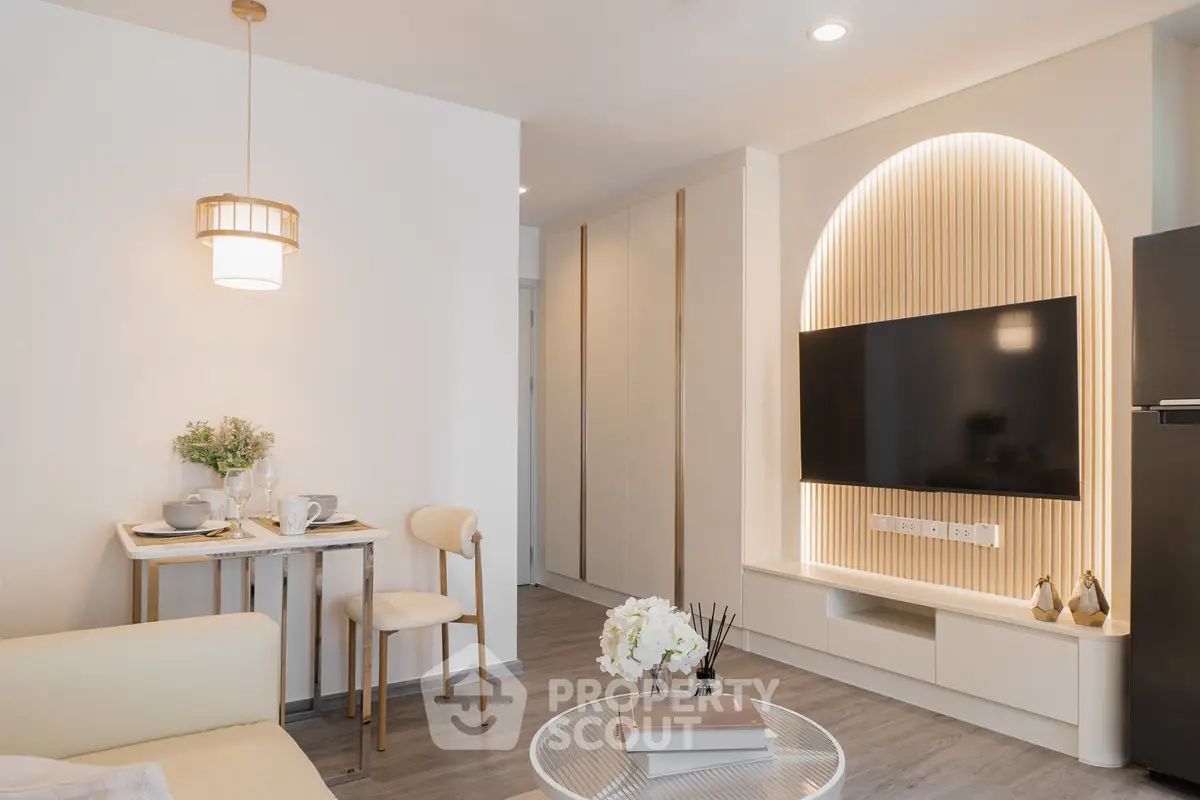Modern living room with stylish decor and built-in TV unit, perfect for cozy urban living.