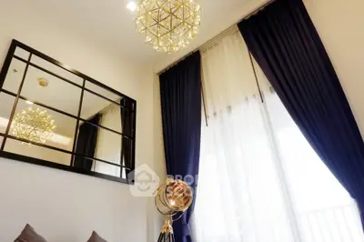 Elegant living room with modern chandelier and floor-to-ceiling curtains