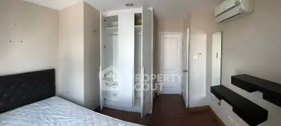 Modern bedroom with built-in wardrobe and air conditioning in a stylish apartment.