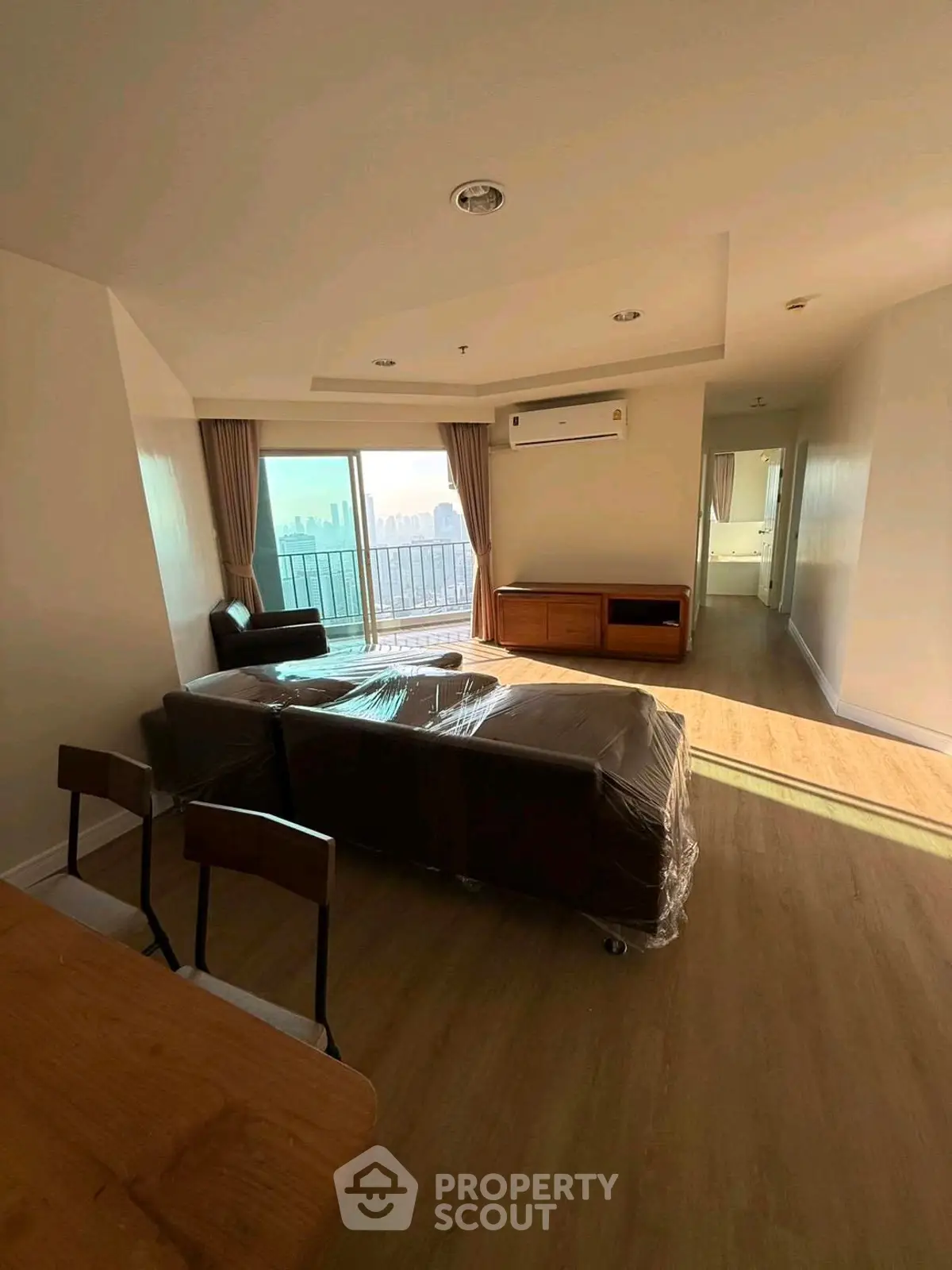 Spacious living room with city view and modern furnishings