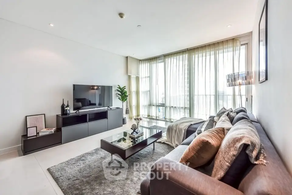 Modern living room with sleek furniture and large windows for natural light