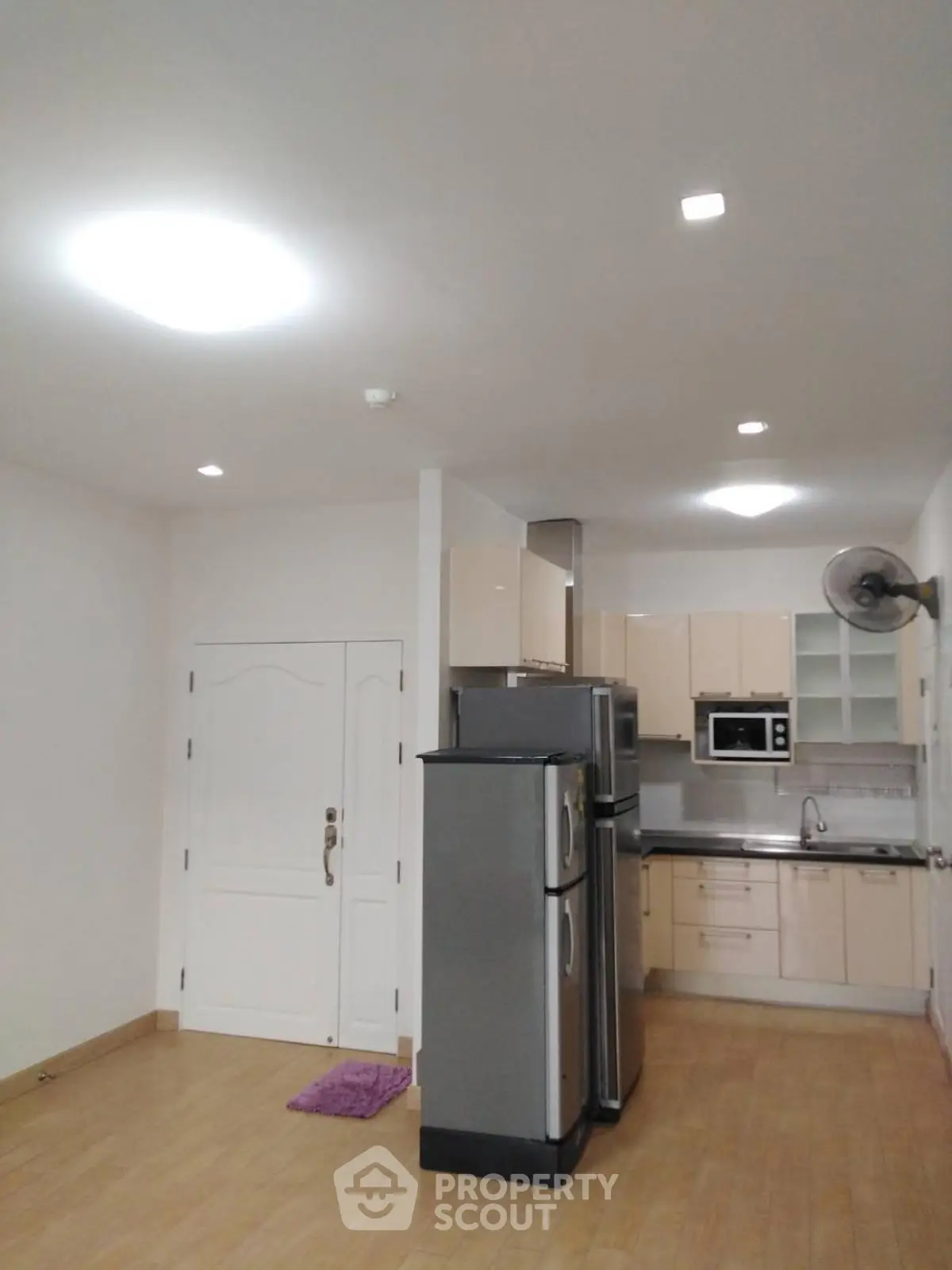 Modern kitchen with stainless steel appliances and wooden flooring