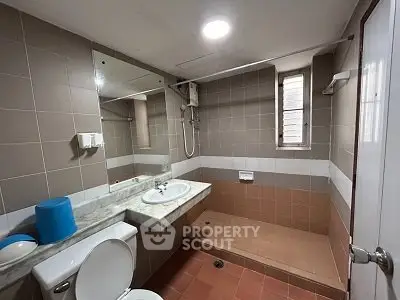 Modern bathroom with shower and sleek design in real estate property.