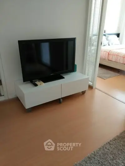 Modern apartment interior with TV stand and cozy bedroom view