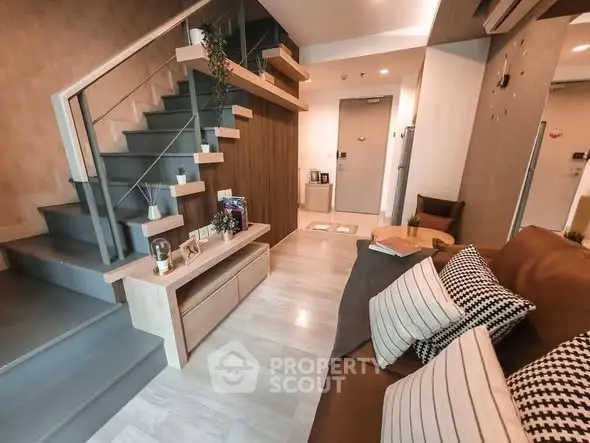 Modern living room with stylish staircase and cozy seating area