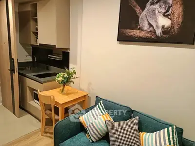 Cozy living room with compact kitchen and stylish decor