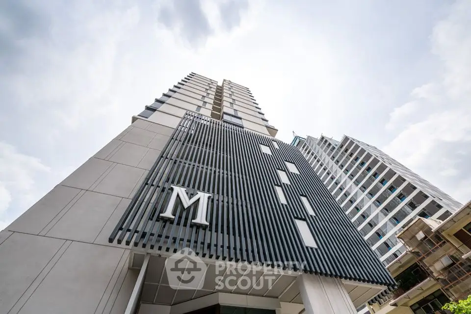 Modern high-rise building with sleek architectural design and prominent facade.