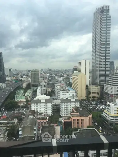 Stunning cityscape view from a high-rise building showcasing urban skyline and architecture.