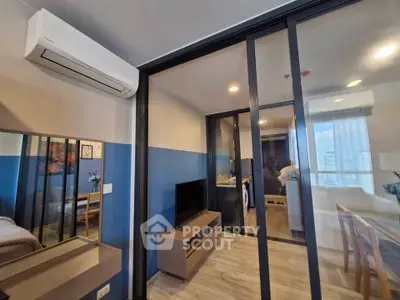 Modern apartment interior with glass partition, air conditioning, and stylish decor.