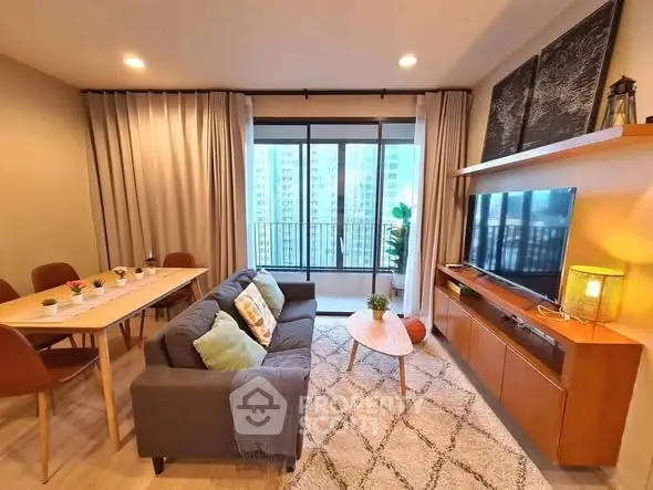 Modern living room with stylish decor and large windows offering city views.